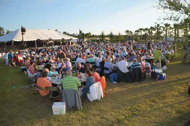 The Palm Coast Arts Foundation's biggest annual event, the Picnics and Pops concert with the Jacksonville Symphony Orchestra, drew a capacity crowd at the foundation's grounds in Town Center Sunday evening, the first time the foundation's stage was used for a pops concert. The audience heard Natan Aspinall lead the orchestra in works starting with Dvorak's Carnival Overture, the first movement of Beethoven's Fifth Symphony, some Copeland and Rimsky-Korsakov, and of course the movie music of John Williams--Harry Potter and Star Wars. (© FlaglerLive)