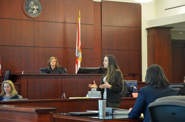 Circuit Judge Margaret Hudson, listening to defense attorney Ashley Kay's opening arguments, is presiding over the trial. She denied a defense motion for mistrial at mid-morning. Click on the image for larger view. (© FlaglerLive)