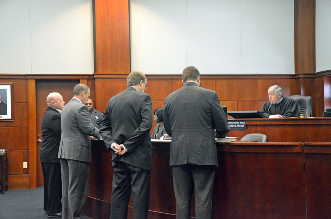 Circuit Judge J. Michael Traynor addressing the prosecution and the defense during the sentencing hearing of Nathaniel Juratovac (far left) in a St. Augustine courtroom in late January. (© FlaglerLive)