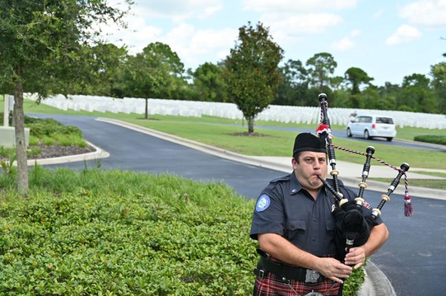 Patrick Juliano, then a lieutenant, practicing his bagpipes moments before the funeral with military honors at Cape Canaveral National Cemetery for Charlie Ericksen, the Flagler County commissioner, who died in 2023. (© FlaglerLive)