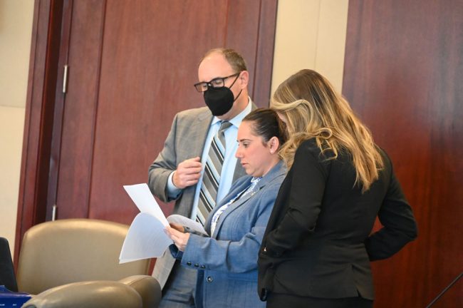 A huddle over jury instructions. From left, Philip Bonamo, an attorney for the defense, Assistant State Attorney Tara Libby, and MaryCatherine Crock, co-counsel with Bonamo. (© FlaglerLive)