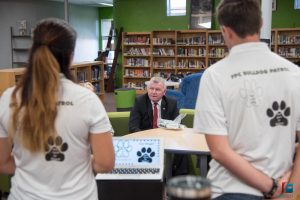 Damien Kelly, who heads Florida’s Office of Safe Schools, listening to FPC's Bulldog Patrol at the school. (Flagler Schools)