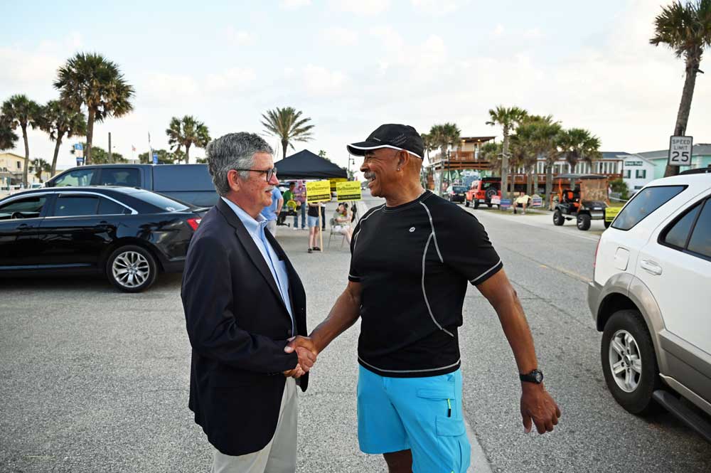 It wasn't a congratulatory handshake just yet--the picture was taken about an hour before polls closed--but it might as well have been: Flagler Beach Commission Chairman Ken Bryan, who decided not to contest his seat, all but passed the torch to Scott Spradley, left, whom Bryan had endorsed. (© FlaglerLive)