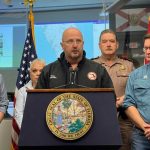 Florida Emergency Management Director Kevin Guthrie addresses reporters on Oct. 3, 2022, at the state Emergency Operations Center, along with other agency heads, including Education Commissioner Manny Diaz, Jr., (to the far right) . Credit: Michael Moline
