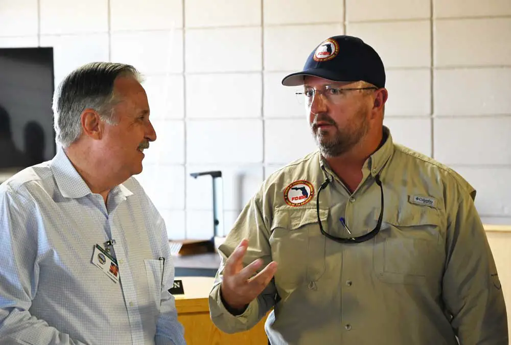 Florida Emergency Management Director Kevin Guthrie, right, with Flagler Beach City Manager William Whitson during Guthrie's last visit to Flagler in mid-October, when he surveyed damage from Hurricane Ian. (© FlaglerLive)