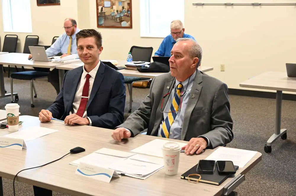 Palm Coast City Council member Nick Klufas, left, attempted earlier this week to have negotiations with the Green Lion Cafe reopened. His motion failed on a 3-2 vote. Mayor David Alfin, right, voted against Klufas's motion. The two council members are seen here at a meeting this morning unrelated to that issue. (© FlaglerLive)