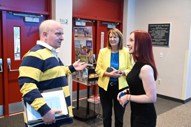 Theodore Kuchar with Auditorium Director Amy Fulmer, center, who had dressed in Ukraine's national colors, and Flagler Youth Orchestra Executive Director Cheryl Tristam. (© FlaglerLive)