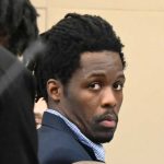 Kwentel Moultrie in court today as one of his defense attorneys, Assistant Public Defender Regina Nunnally, spoke to him. (© FlaglerLive)