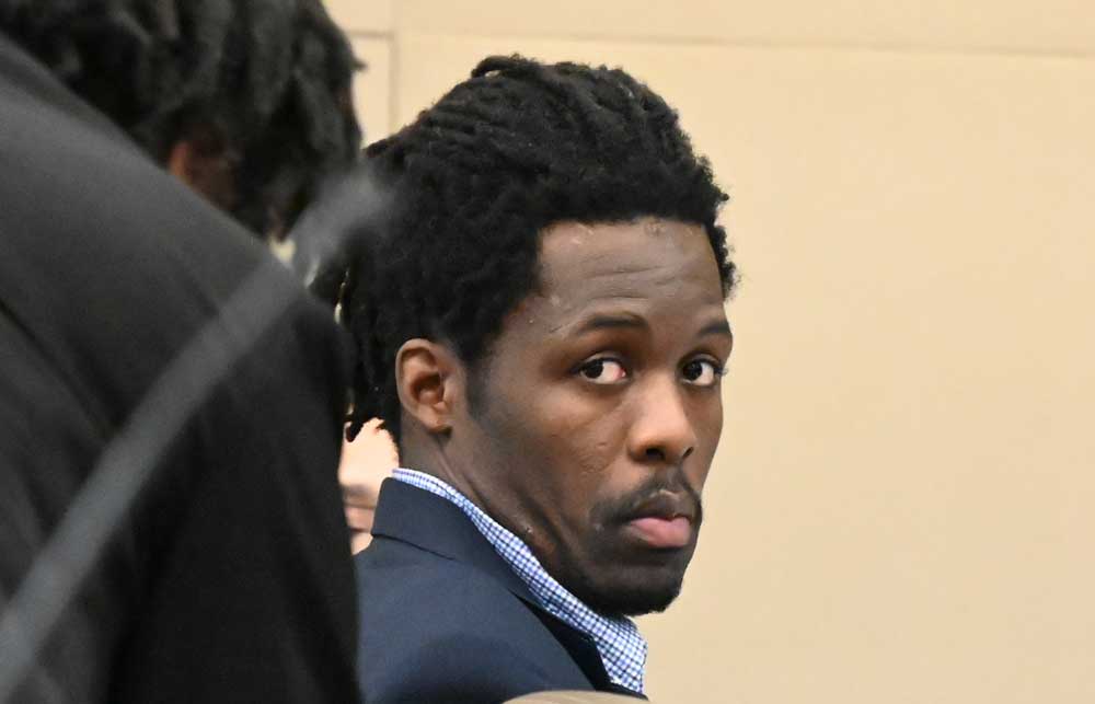 Kwentel Moultrie in court today as one of his defense attorneys, Assistant Public Defender Regina Nunnally, spoke to him. (© FlaglerLive)