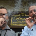 Doing what he loved with one of his closest friends: Ky Ekincy, right, with Mark Woods, outside the Humidor at European Village in 2015. (© FlaglerLive)