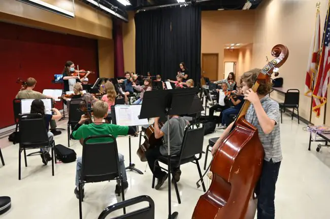 Lacy San Antonio conducts Opus One Strings, the Flagler Youth Orchestra's beginning ensemble, in rehearsal last week at Indian Trails Middle School. (© FlaglerLive)