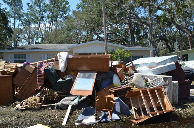 The damage on Lambert Avenue last September, a scene repeated through miles of streets along the Intracoastal in Flagler Beach. (© FlaglerLive)