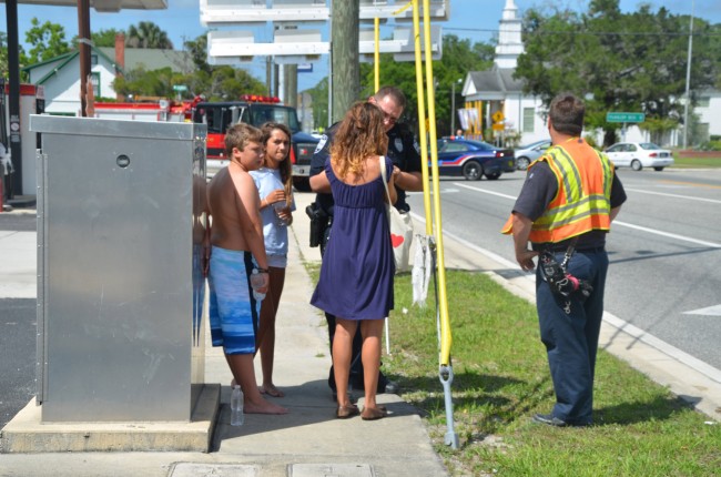 Jasmine Lampley talks to police at the scene as her two passengers, a 13-year-old girl and 11-year-old boy, stand by. Click on the image for larger view. (© FlaglerLive)