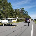 Abdullah Khawja after making the emergency landing on County Road 205 this afternoon. The power lines he swooped under are visible in the background. (Flagler County Professional Firefighters)