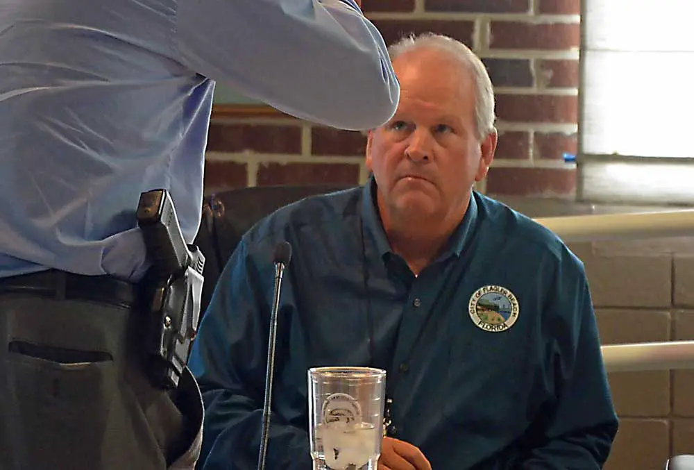 Flagler Beach City Manager Larry Newsom speaking to his police chief at a recent meeting. (© FlaglerLive)