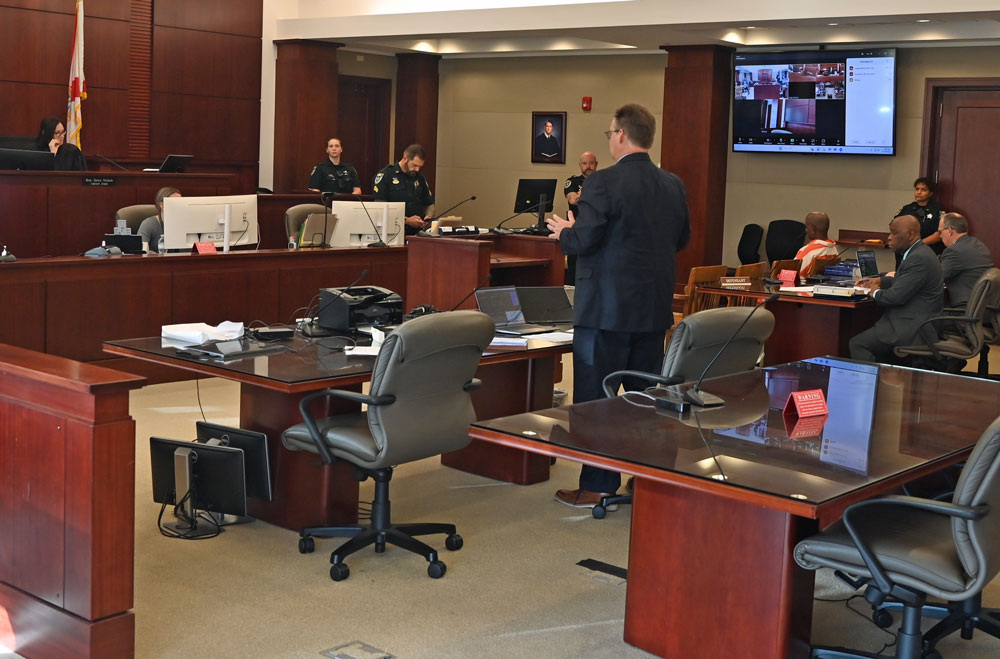 Assistant State Attorney Mark Johnson, in the foreground, arguing against the defense's motions to Circuit Judge Dawn Nichols.