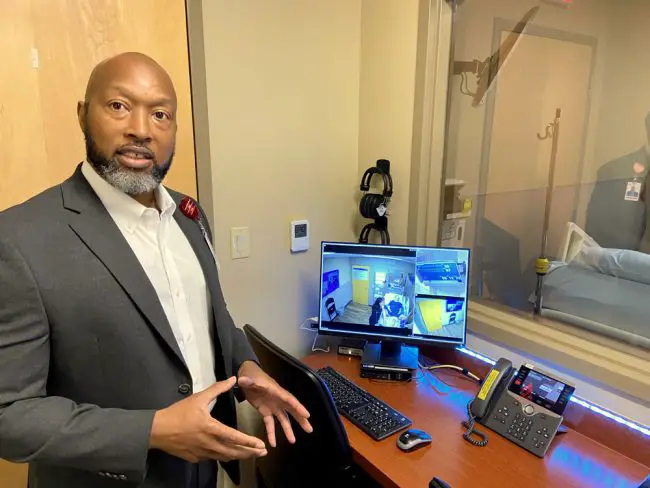 Lee Wright, AdventHealth Regional Sim Center Manager, discusses one of the control stations outside a sim lab at the Palm Coast hospital. (© FlaglerLive)
