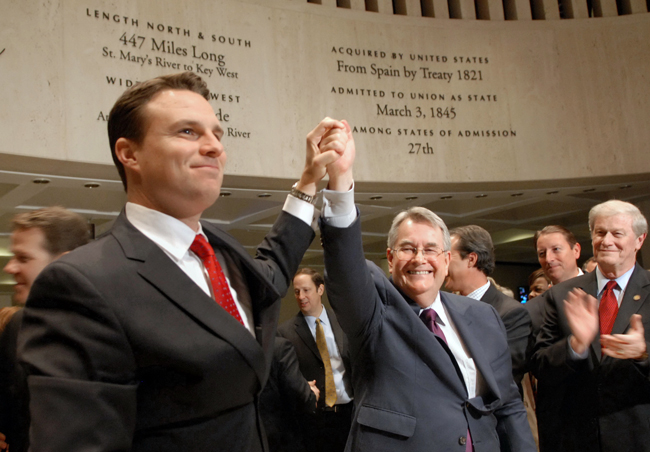 From the left Speaker Will Weatherford, R-Wesley Chapel, and Senate President Don Gaetz, R-Destin, hold their hands high in victory as the 2014 Legislature officially ended "sine die" May 2, 2014. Sen. John Thrasher looks on. (Meredith Geddings)