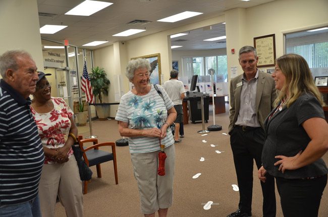 Supervisor of Elections Kaiti Lenhart, right, speaking with the last group of voters--and Jay Gardner, the property appraiser--at the end of a day-long mock election that tested new equipment and introduced voters to new voting machines and to the innards of the elections office on Tuesday. (© FlaglerLive)