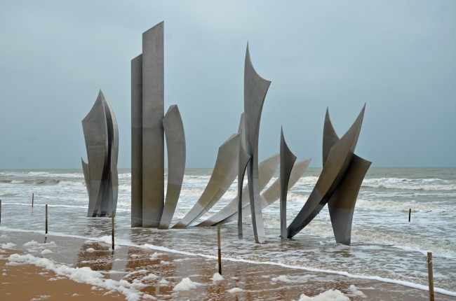 'Les Braves,' on Omaha Beach, a monument installed there in 2004 to commemorate the 60th anniversary of the D-Day landing.  Click on the image for larger view. (© FlaglerLive)