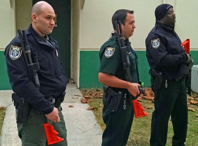 From left, Flagler County Sheriff's deputies Daniel LaVerne,  Craig Rossi and Jason Williams during training with shotguns equipped for less-lethal munitions. 