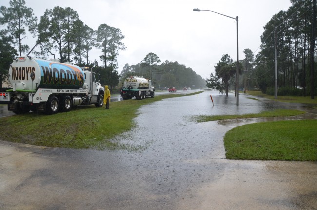 Septic tank trucks waited their turn to suck up to the lift station near the library at Palm Coast Parkway and Belle Terre, where rainfall was reported as high as 15 inches. Click on the image for larger view. (© FlaglerLive)