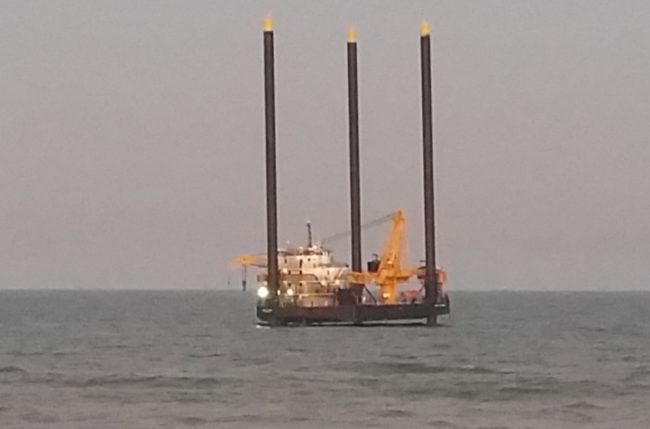 The lift boat as it appeared at sundown just south of the pier in Flagler Beach, in an image taken by Eric Cooley, owner of the 7-Eleven in town. Click on the image for larger view. (© Eric Cooley for FlaglerLive)