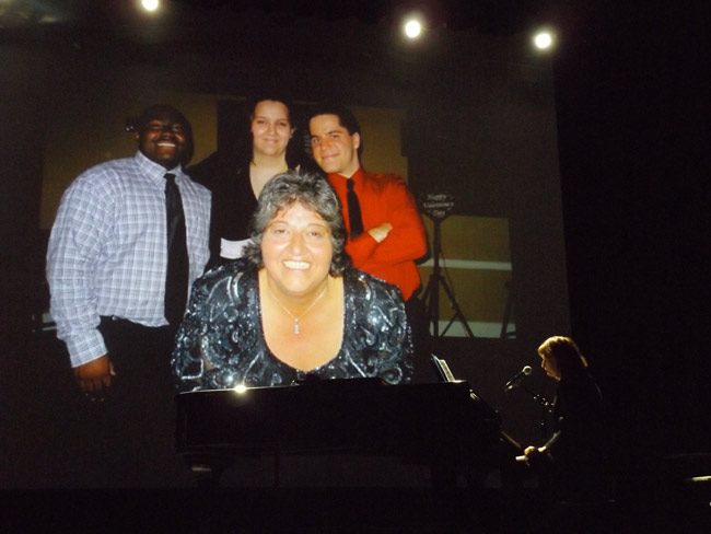 Alana Fitzgerald performing a prelude at the opening of a celebration of the life of Lisa McDevitt, the Flagler Auditorium's long-time executive director, at the auditorium Saturday evening. (© FlaglerLive)