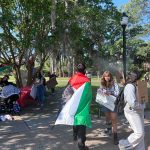 Pro-Palestine protesters at Florida State University move away from a sprinkler during a protest on the Tallahassee campus on April 25, 2024. (Photo by Jackie Llanos)