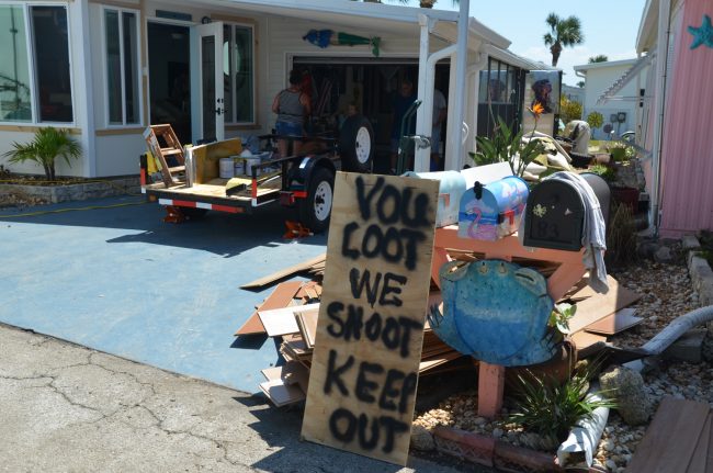 The sign Debbie Whitlock spray-painted this morning and placed outside her home at Surfside Estates in beverly Beach. Click on the image for larger view. (c FlaglerLive)