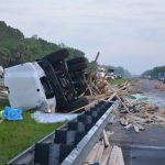 The scene of the crash this morning. Lumber was strewn on both sides of the highway before it was swept from the northbound lanes first, to the right. (© FlaglerLive)