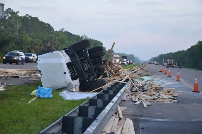 The scene of the crash this morning. Lumber was strewn on both sides of the highway before it was swept from the northbound lanes first, to the right. (© FlaglerLive)
