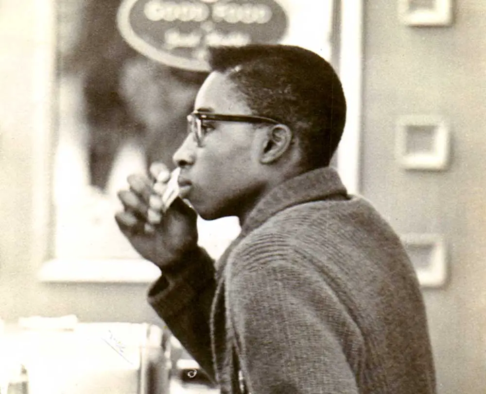 FAMU student Benjamin Cowins tries to get service at a McCrory's lunch counter on February 21, 1961. He looks toward the waitress, who is ignoring him. Two weeks later he was arrested at a Neisners lunch counter, which led to his spending thirty days in jail. The photograph, by Patricia Stephens Due, is part of the Patricia Stephens Due Collection, Florida Memory. 