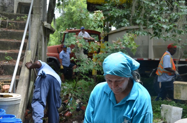 Police and city officials did not give Lynore Camp a choice: she had to make way for city workers to clean up her yard. Click on the image for larger view. (© FlaglerLive)