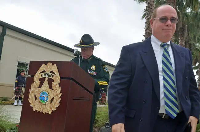 Jim Manfre, in the foreground, walking away from Sheriff Rick Staly after receiving his retirement credentials at Staly's swearing-in, last January. (© FlaglerLive)