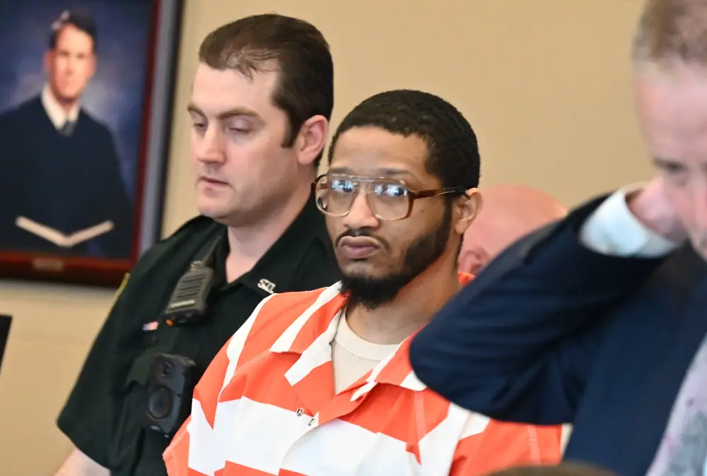 Marcus Chamblin, in the orange and white jail garb, at docket sounding this morning in court. (© FlaglerLive)