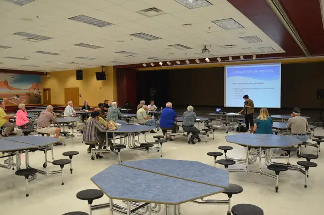 Marilyn Crotty leads the second of four Palm Coast charter review workshops earlier this month at the Indian Trail Middle School cafeteria, where, as has been the case at all three workshops, few people turned up. (© FlaglerLive)