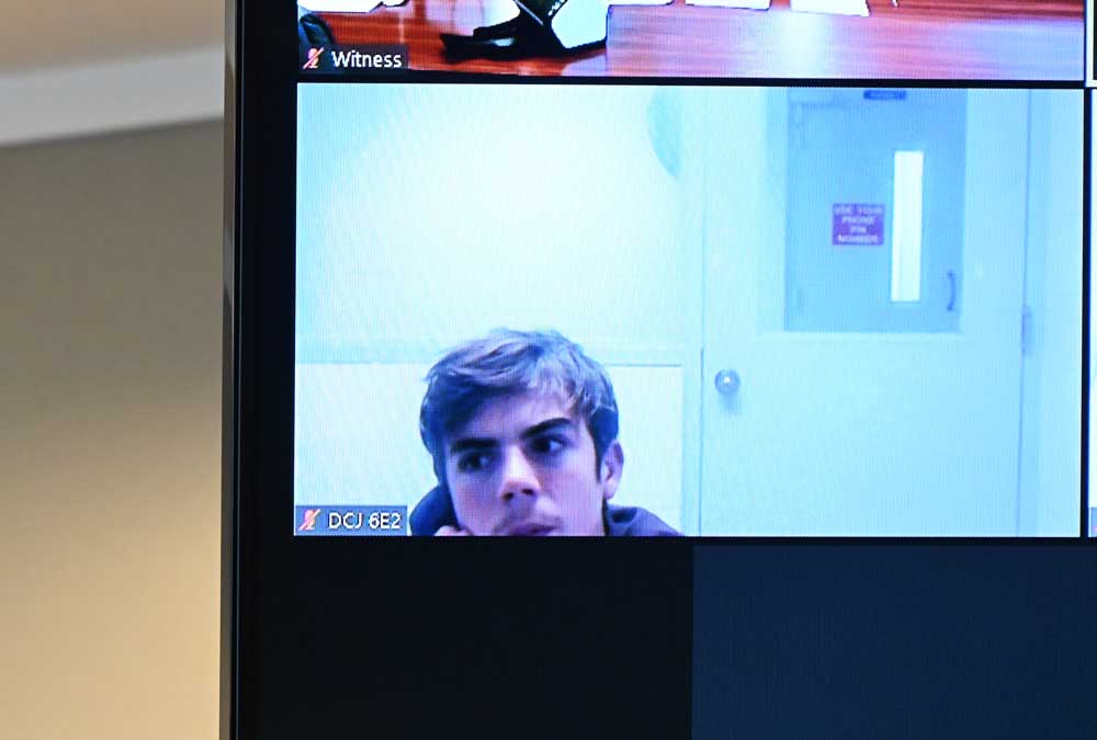 Marshall Thomas appearing from a Duvall County juvenile jail by zoon on an overhead television screen in Circuit Judge Terence Perkins's courtroom this afternoon in Bunnell. (© FlaglerLive)