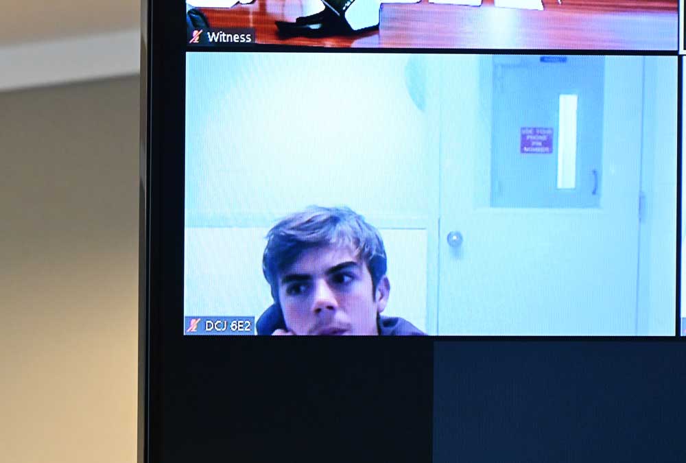 Marshall Thomas appearing from a Duval County juvenile jail by zoon on an overhead television screen in Circuit Judge Terence Perkins's courtroom this afternoon in Bunnell. (© FlaglerLive)