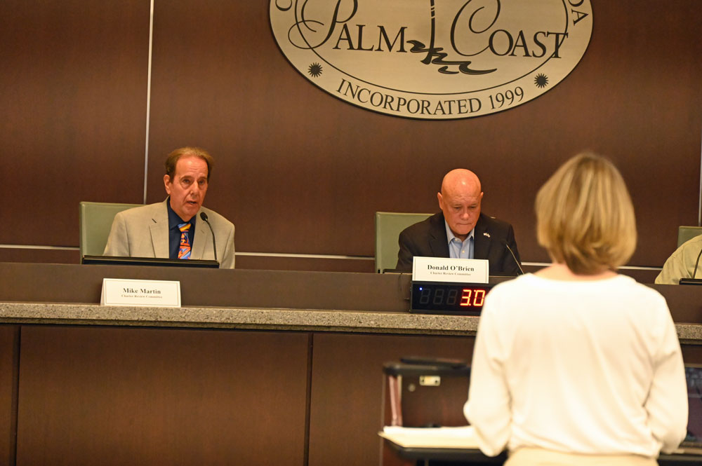 Michael Martin, left, addressing Georgette Dumont, the facilitator of the Charter Review Committee, chaired by Donald O'Brien. (© FlaglerLive)