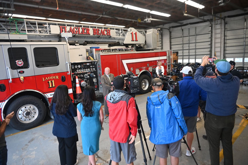Flagler Beach City Manager Dale Martin speaking to the press at the Flagler Beach Fire Department this afternoon. Mayor Patti King was to the right. (© FlaglerLive)