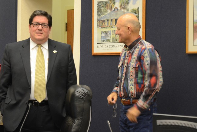 Armando Martinez, left, and Elbert Tucker, who moved to have Martinez essentially fired, by not renewing his contract, Monday evening. The two chatted briefly during a break, before the discussion about the contract. (c FlaglerLive)