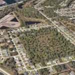 The green square toward the middle is the future site of Matanzas Park, a 104-house subdivision. A strip of Matanzas Woods Parkway is visible in the left corner. U.S. 1 and Sawmill Creek's new houses are in the upper left. North would be toward the upper right. (Google Earth)