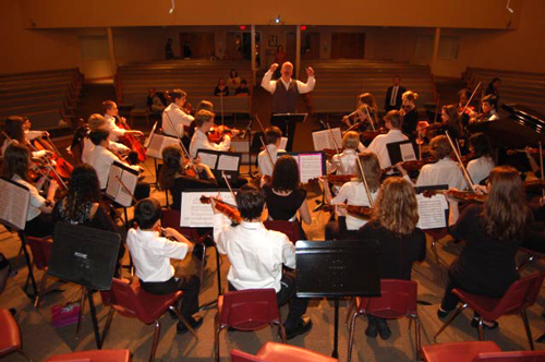 Jonathan May conducting his last performance with the Flagler Youth Orchestra, at the Palm Coast United Methodist Church, in January 2010. (© FlaglerLive)