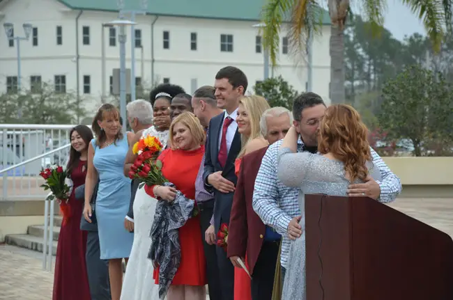 Mazel tov: some of the 16 couples the moment after they became spouses just after noon today in front of the Flagler County courthouse. (© FlaglerLive)