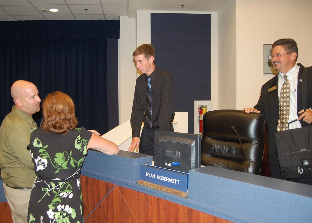 Student Board Member Ryan McDermott, center, speaking with Jacob Oliva, an unidentified woman, and Andy Dance at a School Board meeting in 2010. Oliva went on the become a superintendent here, the Florida Chancellor of Education, and is now the education secretary in Arkansas. Dance served on the School Board for over a decade before election to the County Commission. McDermot went on to the Massachusetts Institute of Technology (MIT), and has been a mechanical engineering manager in Massachusetts. (© FlaglerLive)