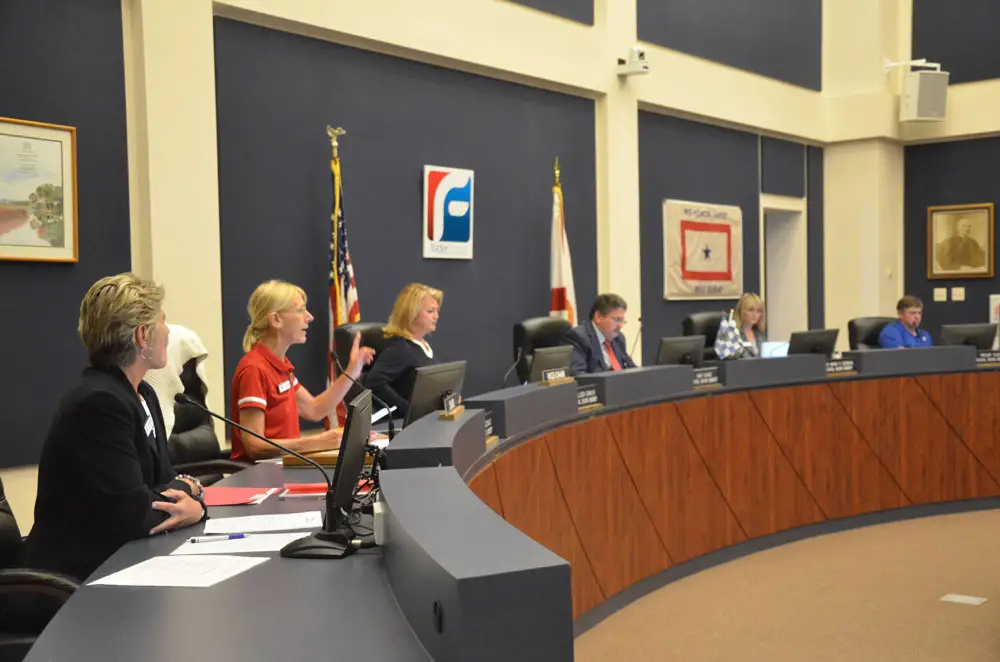School Board Chair Janet McDonald at the beginning of Tuesday evening's meeting. It was Cathy Mittelstadt's first meeting as superintendent. Mittelstadt is in the foreground. (© FlaglerLive)