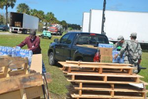 County Commissioner Nate McLaughlin stocked his truck with water and Meals Ready to Eat boxes for delivery to the west side of the county, which has been suffering particularly from power and water shortages. Click on the image for larger view. (c FlaglerLive)