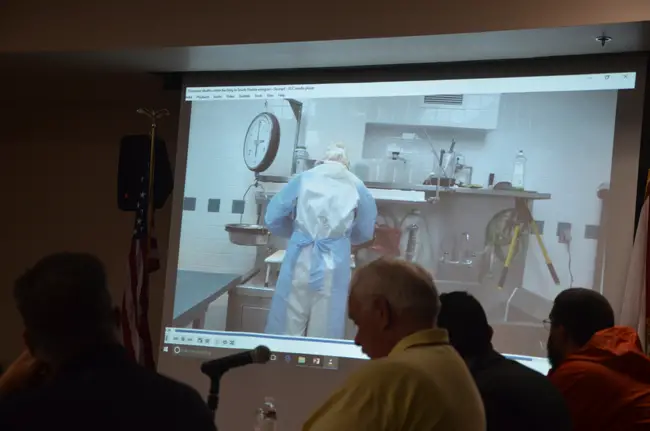 Members of Flagler County's Public Safety Coordinating Council watched a video last year during a discussion on the opioid crisis that included a brief clip showing a medical examiner performing an autopsy on an addiction victim. (c FlaglerLive)