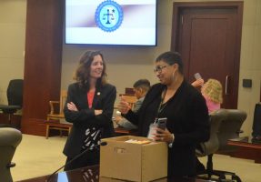 Assistant State Attorney Melissa Clark, left, speaking with a victim's advocate during a break in the trial. (© FlaglerLive)